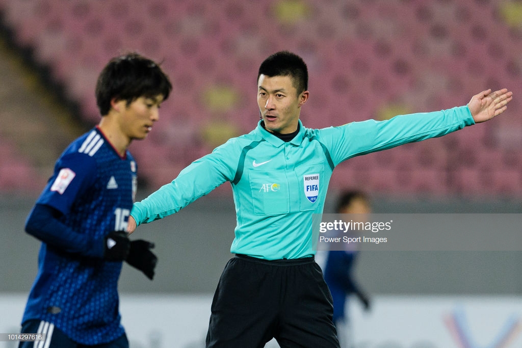 JIANGYIN, CHINA - JANUARY 10: FIFA Referee Fu Ming gestures during the AFC U23 Championship China 2018 Group B match between Japan and Palestine at Jiangyin Sports Center on January 10, 2018, in Jiangyin, China. (Photo by Marcio Rodrigo Machado/Power Sport Images/Getty Images)